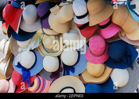 Beach hats selling on the city street. Stock Photo