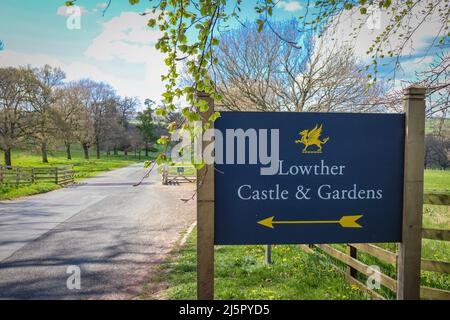 Lowther Castle & Garden Sign, with Road leading in towards the castle Stock Photo