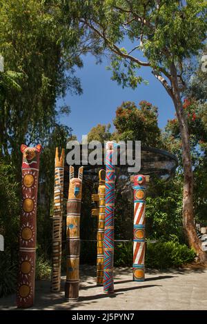 Colorful Australian Totems in the shape of animals in a San Diego zoo forest Stock Photo