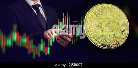 Business men holding bitcoin . Gold bitcoins with Candle stick graph chart and digital background. Stock Photo
