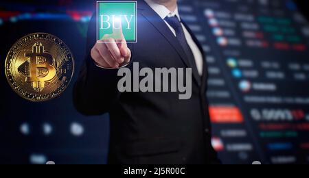 Business men holding bitcoin . Gold bitcoins with Candle stick graph chart and digital background. Stock Photo