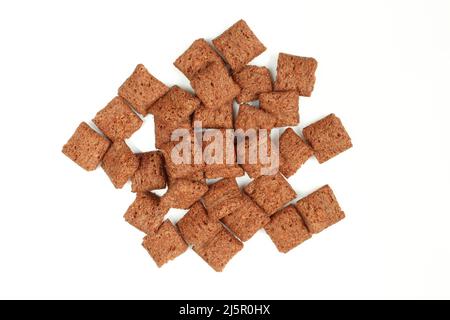 Pile of chocolate pillows isolated on white background.Dry crispy dessert Stock Photo