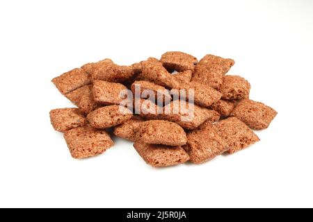 Pile of chocolate pillows isolated on white background.Dry crispy dessert Stock Photo
