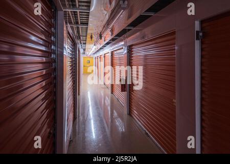 Inside dark self storage facility Stock Photo
