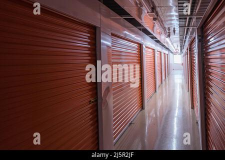 Inside dark self storage facility Stock Photo