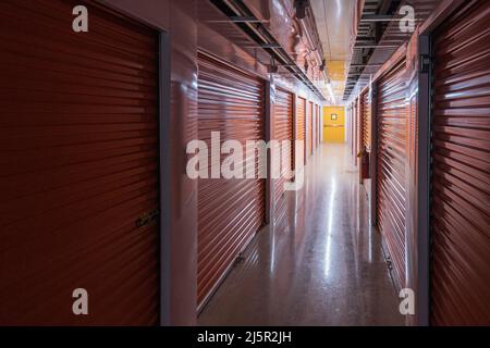 Inside dark self storage facility Stock Photo