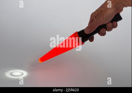 A Maglite torch with a red cone, mostly used in the dark by a traffic controller. Stock Photo