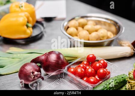 Close-up of fresh tomatoes, onion and celery on table for cooking vegetable salad Stock Photo