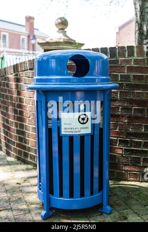 KANNAPOLIS, NC, USA-17 APRIL 2022: Freshly painted bright blue trash recycling receptacle, marked for aluminum, plastic and newspaper. Stock Photo