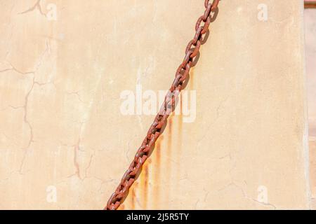 Rusty chains against the wall in San Francisco, California Stock Photo