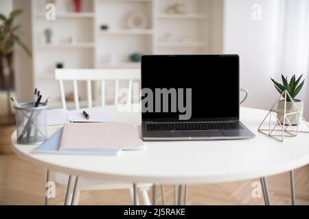 Laptop Computer With Empty Screen Standing On Table At Home Stock Photo