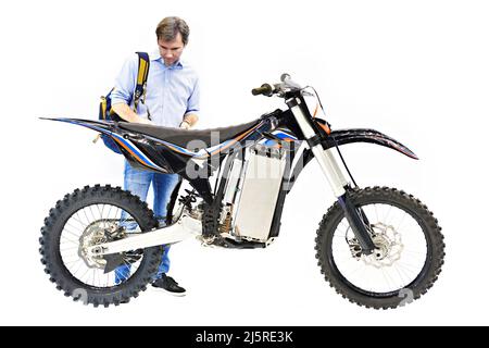Electric motorcycle and buyer isolated on a white background Stock Photo