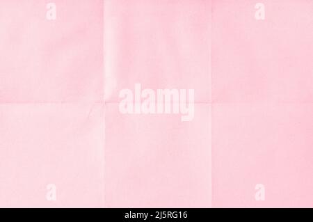 Pink crumpled unfolded paper sheet texture background. Paper folded in six. Full frame Stock Photo