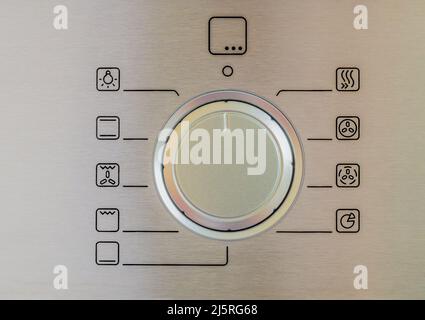 electric oven retractable control dial close up Stock Photo