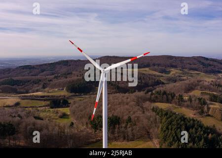 Aerial view of a wind turbine at eye level on a hill with a beautiful view Stock Photo
