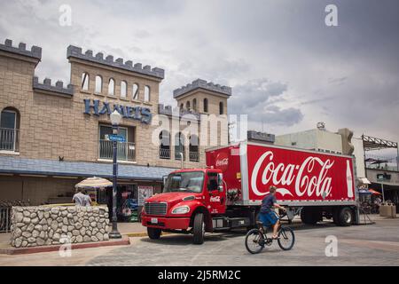 Coca-cola truck parked in front of the castle-shaped Hamel’s Surf shop in Mission Bay, San Diego Stock Photo