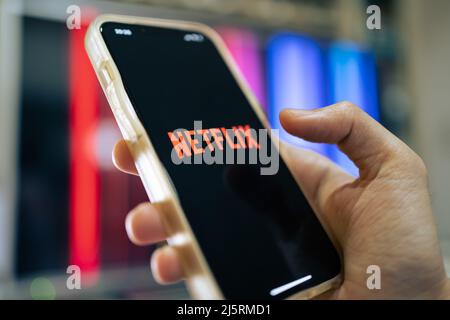 Bangkok, Thailand - April 25, 2022 : iPhone 13 showing its screen with Netflix application. Stock Photo