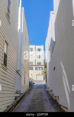 Uphill alleyway in the middle of flat residential buildings in San Francisco, California Stock Photo