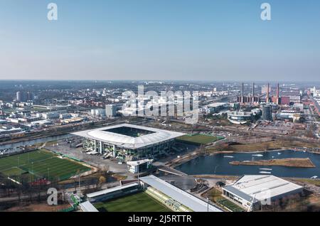 Wolfsburg, Germany - March 2022: Aerial view on Volkswagen Arena and Volkswagen plant industrial area. Cityscape of Wolfsburg. Stock Photo