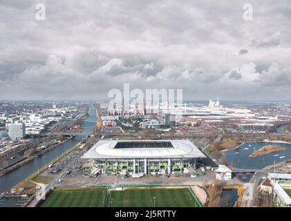 Wolfsburg, Germany - March 2022: Aerial view on Volkswagen Arena and Volkswagen plant industrial area. Cityscape of Wolfsburg. Stock Photo