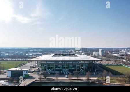 Wolfsburg, Germany - March 2022: Aerial view on Volkswagen Arena and Volkswagen plant industrial area. Cityscape of Wolfsburg. Stock Photo