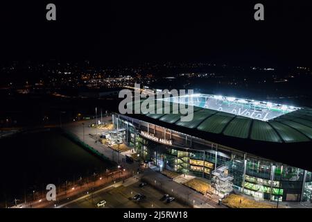 Wolfsburg, Germany - March 2022: Aerial night view on the illuminated Volkswagen Arena stadium after VfL Wolfsburg Bundesliga match Stock Photo