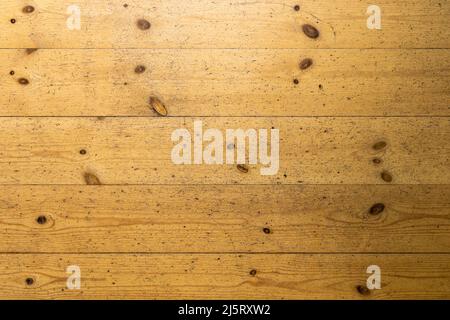 Worn wooden floor in an old building. Background texture of timber planks in a row. Used vintage board. Natural material structure from the interior. Stock Photo