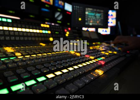 TV editor working with vision mixer in television broadcast gallery Stock Photo