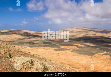 Aerial view of the volcanic landscape of Lanzarote featuring black ...