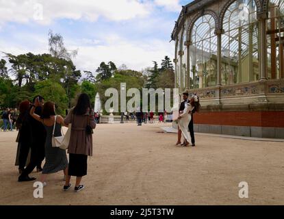 Madrid, Spain, 12.04.2022. Photo shooting of bridal couple in front of Crystal Palace, Palacio de Cristal, in Retiro Park. Madrid, Spain. Stock Photo