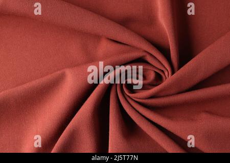 Red silk luxury drapery fabric texture background closeup Stock Photo