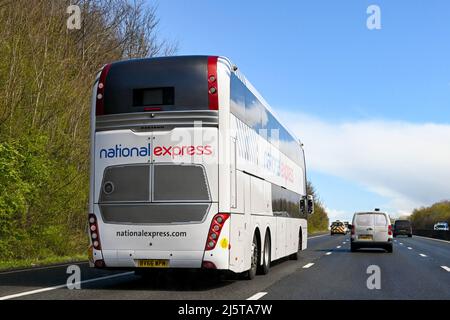 Bristol, England - April 2022: Rear view of a double decker express coach on the M4 motorway. The bus is operated by National Express. Stock Photo