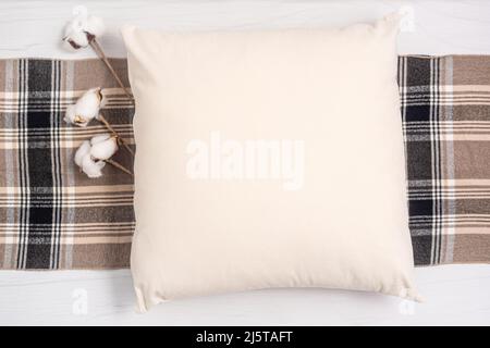 Beige pillow blank mockup on white wood background Stock Photo