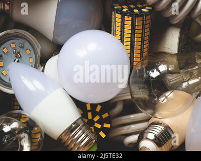 Types of light bulbs: Light Emitting Diode, Fluorescent, Incandescent. Variety of light bulb shapes and sizes, its base or plug type, close up Stock Photo