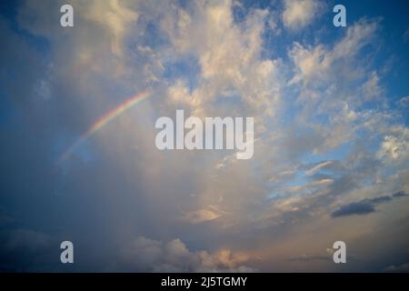 Drone field of view of rainbow in cloudy sky on the paradise island of Mahe, Seychelles. Stock Photo