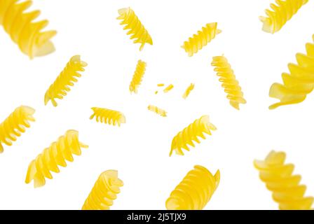 Collection of Italian Pasta fusilli falling isolated on white background. Selective focus Stock Photo