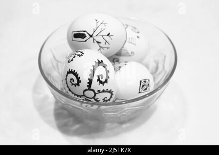 Defocus black and white eggs on white background. Minimal Easter celebration concept. Design, visual art, minimalism. Balance and harmony concept. Men Stock Photo