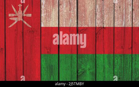 Top view of Old Painted Flag of Oman on Dark Wooden Fence, wall. patriot and travel concept. no flagpole. Plane design, layout. Flag background Stock Photo