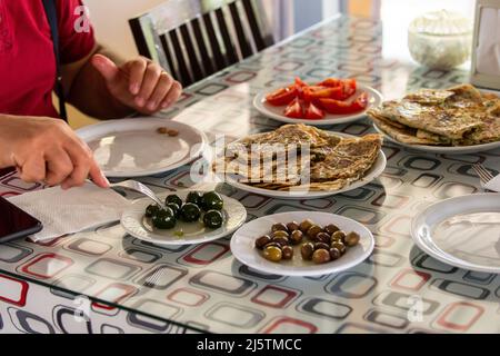 The man having breakfast at the village breakfast table. Varieties of breakfast in Turkey Stock Photo