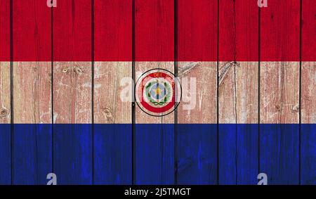 Top view of Old Painted Flag of Paraguay on Dark Wooden Fence, wall. patriot and travel concept. no flagpole. Plane design, layout. Flag background Stock Photo