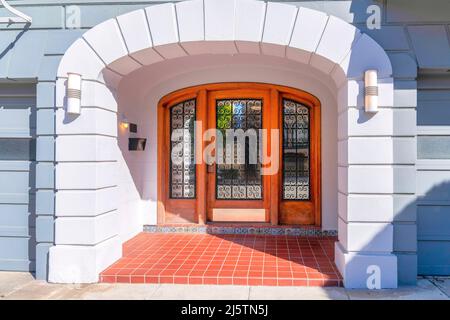Large wooden front door with ornate reflective glass panels in San Francisco, California Stock Photo