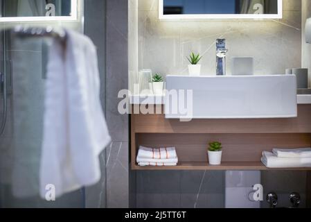 washbasin in the bathroom and towel foreground Stock Photo