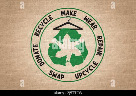 Circular Economy Textiles logo on fabric, make, wear, repair, upcycle, swap, donate, recycle with eco clothes recycle icon sustainable fashion concept Stock Photo