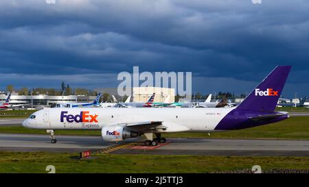 Everett, WA, USA - April 21, 2022; FedEx Express aircraft taxiing at Everett Paine Field. The freight plane is a converted Boeing 757-200 Stock Photo