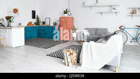 Interior of modern kitchen with counters, sofas and red fridge Stock ...