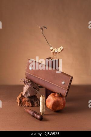 Still life with leather purse and tools. Stock Photo