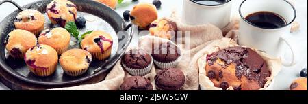 Muffins assortment on light background. Freshly baked cupcakes. Celebration concept. panorama Stock Photo