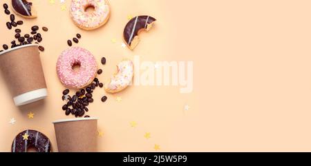 Donuts with coffee on yellow background. Bakery, baking concept. Flat lay, top view, copy space Stock Photo