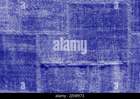 Detail of old asian patchwork carpet background and texture. Close up. Trendy color of the year 2022 . Ultra Violet creative and moody color of the pi Stock Photo