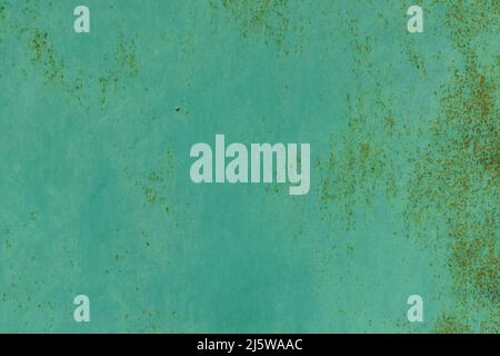Texture of painted surface with small rust spots. Old metal surface painted with green paint, that has begun to rust, background, high resolution. Stock Photo